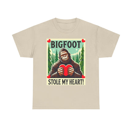 This tee features a bigfoot graphic with Bigfoot holding a heart and smiling. It says "Bigfoot Stole My Heart!" It's perfect for Bigfoot lovers of all ages. This tee is neutral in color