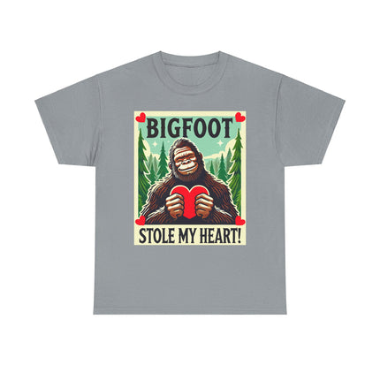 This tee features a bigfoot graphic with Bigfoot holding a heart and smiling. It says "Bigfoot Stole My Heart!" It's perfect for Bigfoot lovers of all ages. This tee is silver