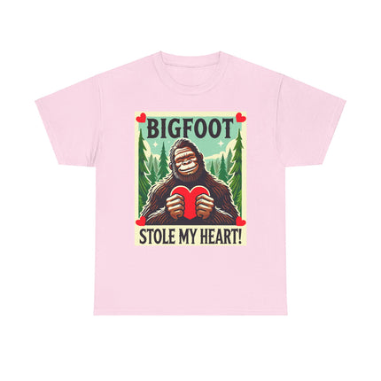 This tee features a bigfoot graphic with Bigfoot holding a heart and smiling. It says "Bigfoot Stole My Heart!" It's perfect for Bigfoot lovers of all ages. This tee is light pink