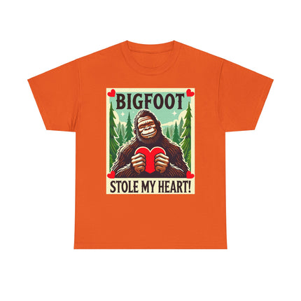 This tee features a bigfoot graphic with Bigfoot holding a heart and smiling. It says "Bigfoot Stole My Heart!" It's perfect for Bigfoot lovers of all ages. This tee is orange