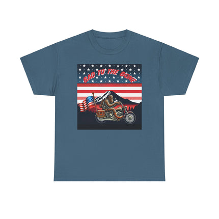 This tee has bigfoot riding on a motorcycle with an American flag hanging off the back. he's riding in front of a mountain that's in front of a patriotic background of stars and stripes. This tee is blue